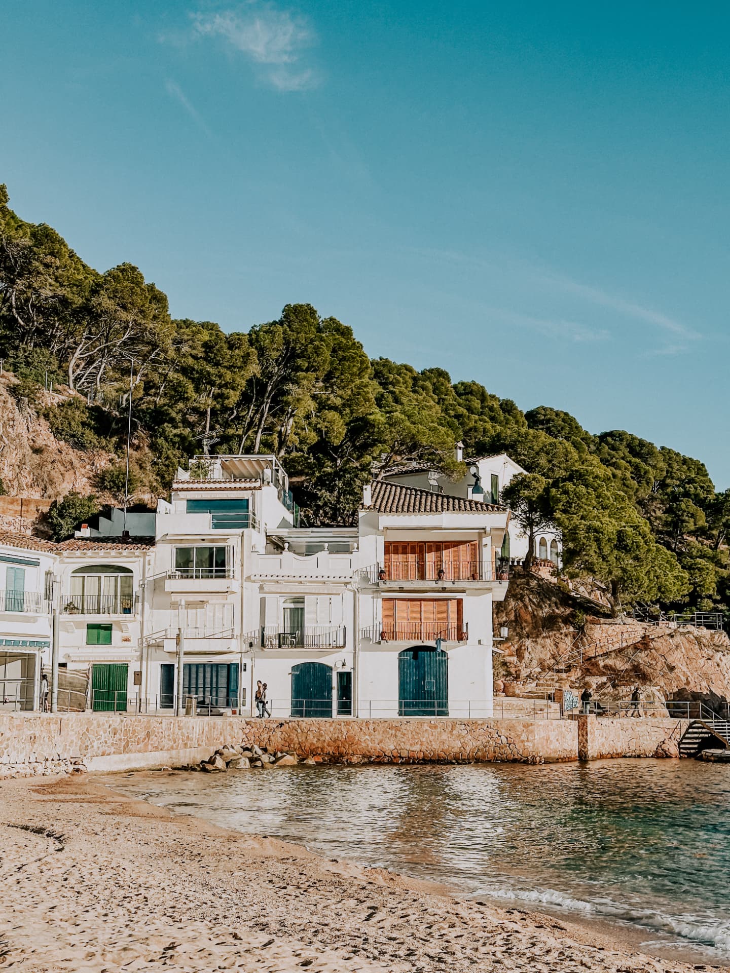 White fishing cottages beside crystal-clear water